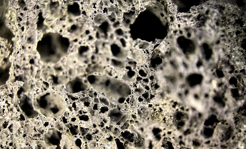 macro photograph piece porous rock with texture LIV Hospital