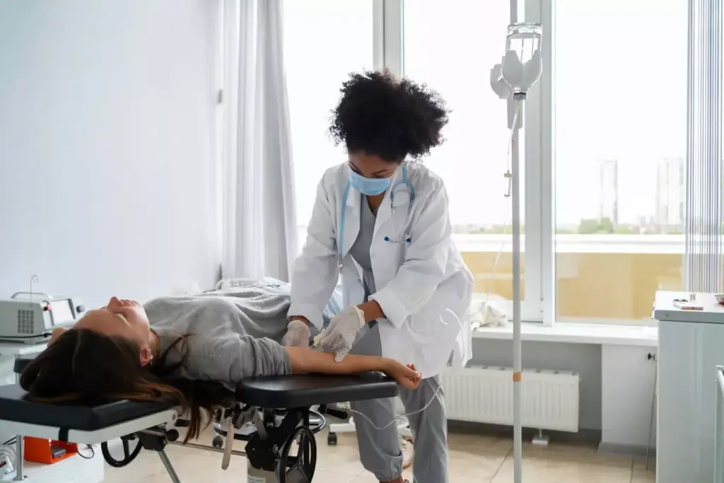 A clinical hospital setting, with a patient's hand receiving an intravenous chemotherapy infusion. The foreground shows the patient's arm connected to a clear IV bag suspended from a metal pole, the tubing gently flowing the medicinal liquid into the vein. The middle ground features medical equipment and monitoring devices, conveying the advanced technology used in cancer treatment. The background depicts a calm, sterile environment with crisp lighting, clean surfaces, and a sense of medical professionalism. The overall mood is one of hope and determination, as the patient undergoes the essential therapy to target and eliminate cancer cells.