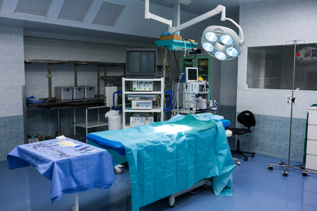 A clinical laboratory setting, with bright overhead lighting illuminating a metal examination table. On the table, a cadaveric human femur bone lies exposed, ready for harvesting. Medical personnel in sterile garb, gloves, and masks carefully examine the bone, assessing its integrity and suitability for use in spinal fusion grafts. In the background, shelves of labeled bone and tissue samples hint at the meticulous process of procuring, testing, and preparing these precious anatomical specimens for medical procedures. An atmosphere of reverence and scientific precision pervades the scene, underscoring the vital role these cadaver-derived materials play in advancing orthopedic treatments.