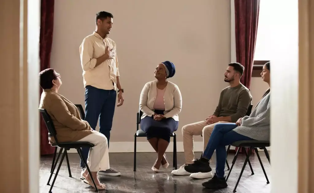 A clinical, well-lit interior setting featuring a group therapy session for substance abuse treatment. In the foreground, a diverse group of adults sitting in a circle, engaged in discussion, conveying a sense of support and healing. The middle ground showcases various treatment modalities such as counseling, medication management, and wellness activities. The background subtly depicts the progression of recovery, with inspirational imagery and motivational quotes on the walls. The overall scene radiates a sense of hope, empowerment, and the determination to overcome addiction, reflecting the growing crisis of substance abuse in America.