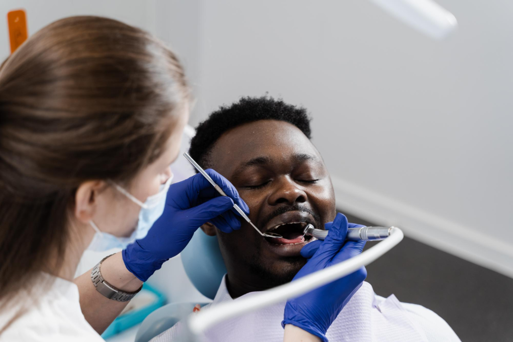 A close-up view of a dental bone grafting procedure, showcasing the intricate surgical process. In the foreground, a skilled surgeon's hands delicately manipulate dental instruments, carefully placing the graft material into the jawbone. The middle ground reveals the patient's open mouth, with the surgical site exposed, allowing for a detailed examination of the bone density and contours. The background is blurred, creating a sense of focus and depth, while the lighting is soft and diffused, highlighting the precision and care of the procedure. The overall mood is one of clinical professionalism and attention to detail, conveying the importance of this specialized dental treatment. A close-up view of a dental bone grafting procedure, showcasing the intricate surgical process. In the foreground, a skilled surgeon's hands delicately manipulate dental instruments, carefully placing the graft material into the jawbone. The middle ground reveals the patient's open mouth, with the surgical site exposed, allowing for a detailed examination of the bone density and contours. The background is blurred, creating a sense of focus and depth, while the lighting is soft and diffused, highlighting the precision and care of the procedure. The overall mood is one of clinical professionalism and attention to detail, conveying the importance of this specialized dental treatment.