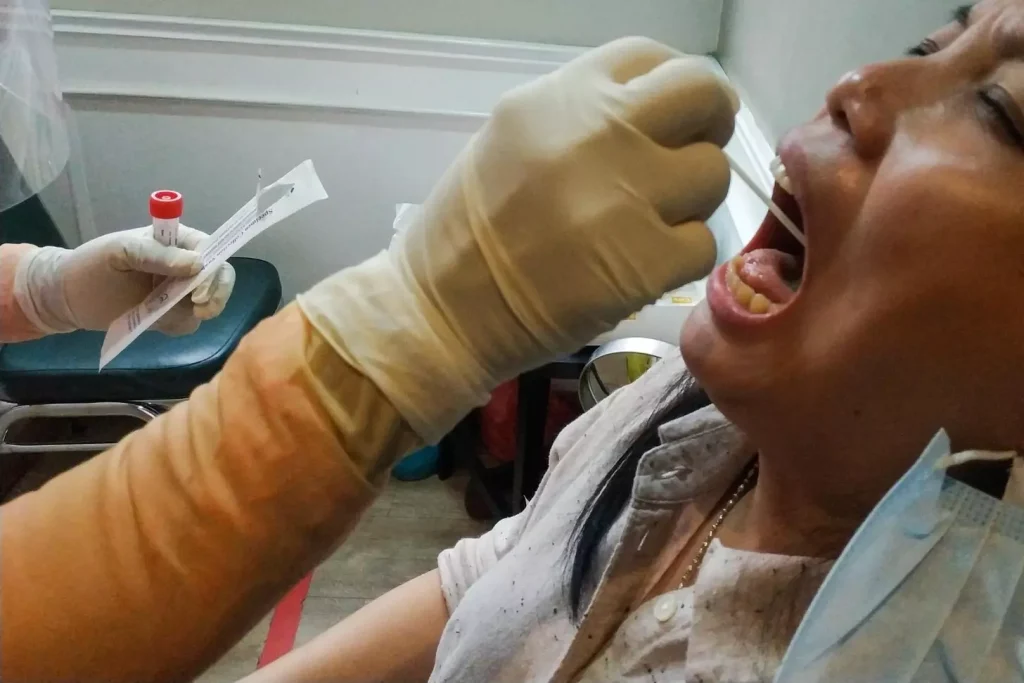A close-up view of a dental procedure, showcasing the use of autografts. In the foreground, a surgeon's hand carefully extracts a small bone graft from the patient's jaw. The extracted bone appears as a natural, irregular shape, with a slightly porous texture. The middle ground features the surgical site, with the underlying bone structure and surrounding soft tissues visible. The lighting is soft and directional, casting subtle shadows that accentuate the contours of the bone and tissue. The background is blurred, creating a clinical, focused atmosphere that draws the viewer's attention to the intricate details of the autograft harvesting process.
