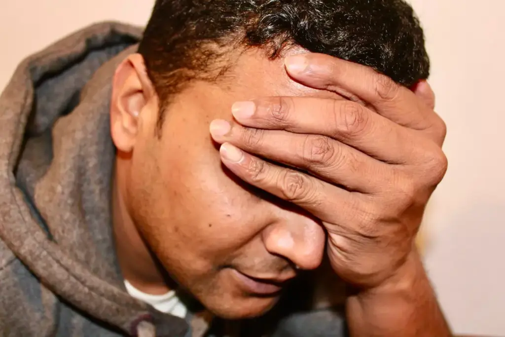 A close-up view of a person's head with a pained expression, showing the effects of chemotherapy-induced headache. The forehead is creased, and the temples are clenched, conveying the intense discomfort. The skin appears slightly flushed, with a subtle sheen of perspiration, reflecting the physiological response to the headache. The lighting is soft and diffused, creating a somber and introspective mood. The background is blurred, placing the focus entirely on the subject's face and the visible symptoms of the condition. A close-up view of a person's head with a pained expression, showing the effects of chemotherapy-induced headache. The forehead is creased, and the temples are clenched, conveying the intense discomfort. The skin appears slightly flushed, with a subtle sheen of perspiration, reflecting the physiological response to the headache. The lighting is soft and diffused, creating a somber and introspective mood. The background is blurred, placing the focus entirely on the subject's face and the visible symptoms of the condition.