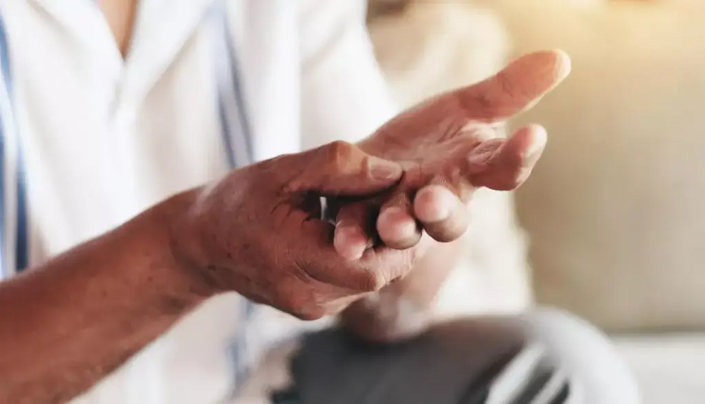 A detailed close-up illustration of a human hand and forearm, showcasing the effects of C5 palsy, a neurological complication. The hand appears weakened and drooping, the fingers unable to fully extend. The forearm musculature is visibly atrophied, with a noticeable loss of tone and definition. Soft, natural lighting illuminates the scene, casting gentle shadows that accentuate the anatomical details. The background is muted and slightly blurred, keeping the focus on the impaired hand and arm. The overall mood is one of clinical documentation, highlighting the physical impact of this debilitating condition.
