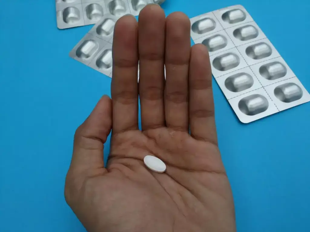 A detailed close-up of a person's hand, palm facing up, with visible veins and discoloration due to the effects of chemotherapy and steroids. The hand is surrounded by a soft, diffused light, creating a somber and introspective atmosphere. In the middle ground, various pill bottles and medical supplies are scattered, symbolizing the aftermath of the grueling cancer treatment. The background is blurred and muted, suggesting the sense of isolation and personal struggle experienced during this phase of recovery. The overall mood is one of vulnerability, resilience, and the lingering physical and emotional impact of the treatment. A detailed close-up of a person's hand, palm facing up, with visible veins and discoloration due to the effects of chemotherapy and steroids. The hand is surrounded by a soft, diffused light, creating a somber and introspective atmosphere. In the middle ground, various pill bottles and medical supplies are scattered, symbolizing the aftermath of the grueling cancer treatment. The background is blurred and muted, suggesting the sense of isolation and personal struggle experienced during this phase of recovery. The overall mood is one of vulnerability, resilience, and the lingering physical and emotional impact of the treatment.