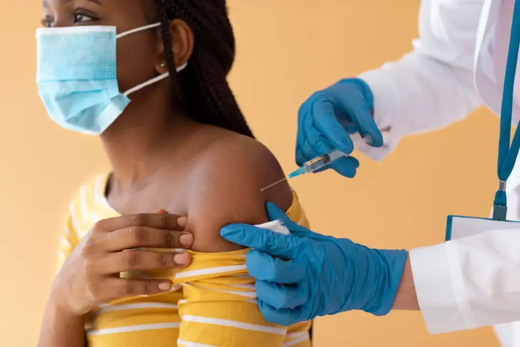 A detailed, photorealistic medical illustration depicting the process of TC chemotherapy for breast cancer. In the foreground, a gloved hand carefully administers an intravenous infusion of the chemotherapeutic drugs into a patient's arm, with medical tubing and equipment visible. In the middle ground, a cross-section of a human breast is shown, highlighting the affected tumor and surrounding tissue. The background depicts a modern oncology clinic, with clean, well-lit examination rooms and state-of-the-art medical technology. The overall mood is clinical yet compassionate, conveying the gravity of the treatment while also suggesting the care and expertise of the medical professionals involved.