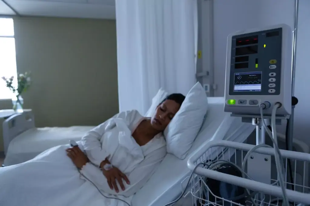 A dimly lit hospital room, the air heavy with a sense of resignation. A frail figure lies in the bed, face etched with the strain of a brain tumor's relentless progression. Soft, ambient lighting casts long shadows, highlighting the weariness in their features. Medical equipment beeps softly, a constant reminder of the precarious nature of their condition. The room's atmosphere is one of quiet contemplation, a solemn acknowledgment of the inevitable. This scene captures the poignant moment when the end of life signs of Glioblastoma Multiforme become undeniable, signaling the need to prepare for the final chapter.