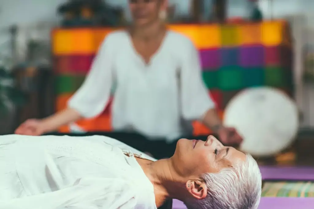 A dimly lit rehabilitation center, with an atmosphere of hope and healing. In the foreground, a patient in deep contemplation, their face a canvas of determination and resolve. The middle ground features a team of compassionate medical professionals, their expressions conveying empathy and support. In the background, a serene landscape of rolling hills, symbolizing the tranquil journey of recovery. Soft, warm lighting casts a glow upon the scene, creating a sense of comfort and safety. The overall composition evokes a sense of progress, with the patient at the center of a supportive and nurturing environment.