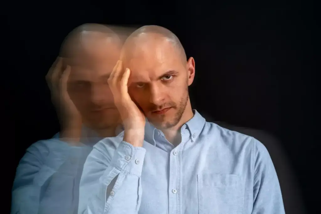 A disoriented, blurred vision with a prominent central blind spot, depicting the visual disturbances caused by a brain tumor. In the foreground, a distorted, partially obscured human eye, its iris and pupil slightly out of focus. The middle ground features a hazy, dreamlike landscape, with soft, muted colors and a sense of depth and distance. In the background, a faint silhouette of the human brain, partially obscured by a subtle, ominous shadow, symbolizing the impact of the tumor on the visual cortex. The lighting is subdued, creating a moody, unsettling atmosphere, conveying the disruptive effects of the brain cancer on the subject's vision.