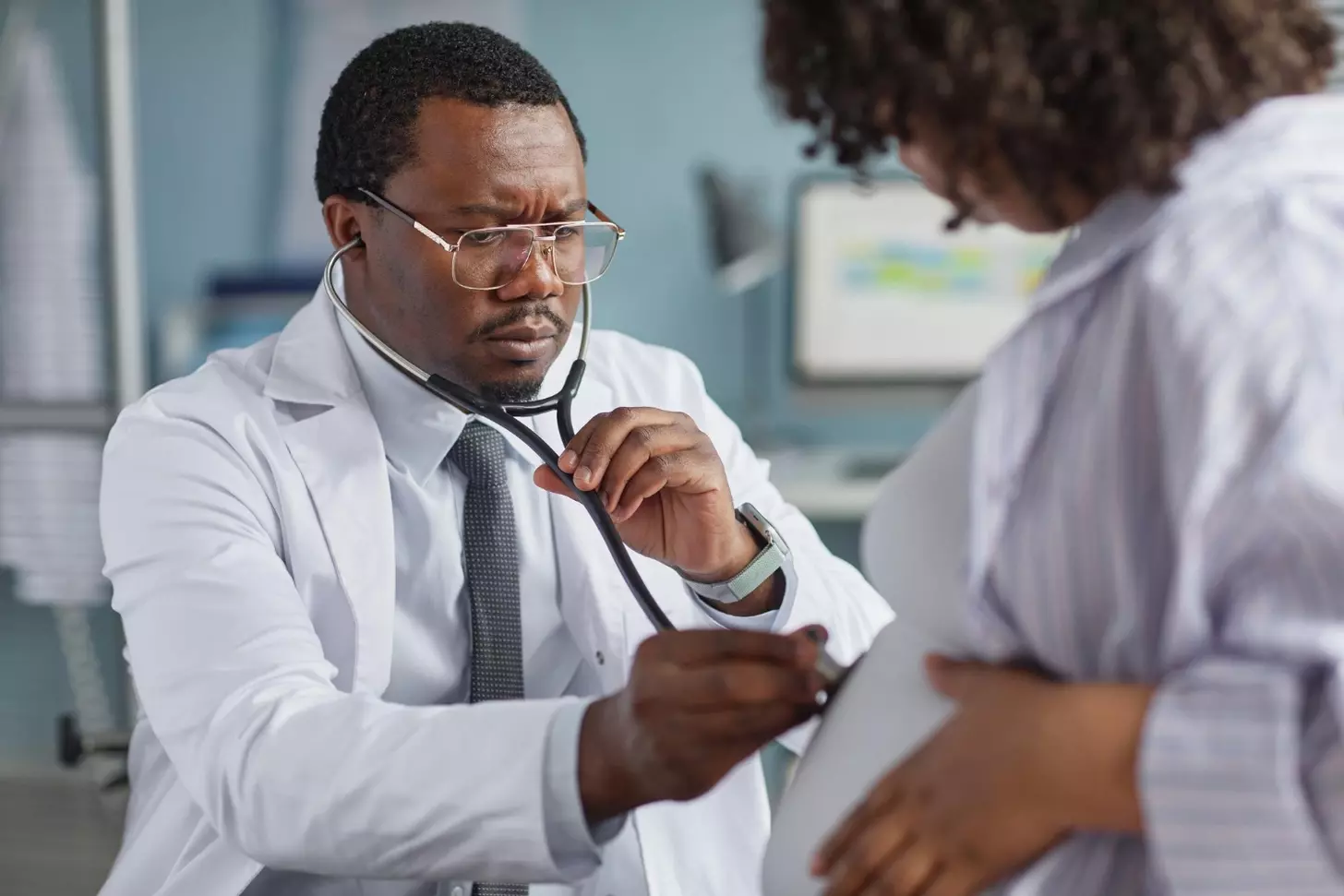 A doctor examining a pregnant woman