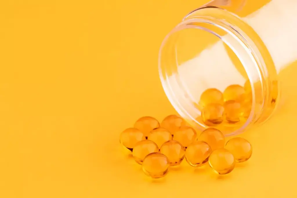 A glass container holding several orange and white capsules, arranged neatly on a reflective surface. The capsules are surrounded by a soft, diffused light, creating a warm and soothing atmosphere. In the background, a blurred, neutral-toned backdrop provides a clean and minimalist setting, allowing the pharmaceuticals to be the focal point. The composition is balanced and visually appealing, conveying the power and efficacy of oral NSAIDs for joint pain relief.