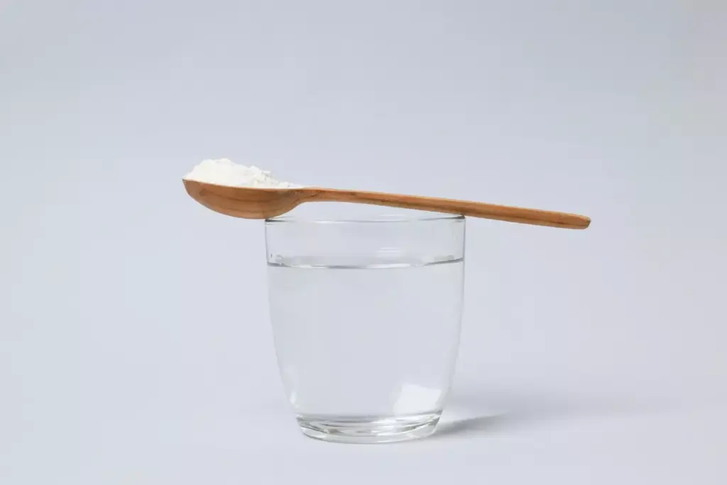 A glass filled with a clear saltwater solution, steam rising gently, placed on a simple wooden surface. In the foreground, a spoon and a small pile of baking soda. Soft, natural lighting casts a soothing, homely atmosphere. The composition emphasizes the simplicity and practicality of this time-honored remedy for chemo-induced sore throat, inviting the viewer to envision the restorative, comforting ritual of gently rinsing the mouth and throat. A glass filled with a clear saltwater solution, steam rising gently, placed on a simple wooden surface. In the foreground, a spoon and a small pile of baking soda. Soft, natural lighting casts a soothing, homely atmosphere. The composition emphasizes the simplicity and practicality of this time-honored remedy for chemo-induced sore throat, inviting the viewer to envision the restorative, comforting ritual of gently rinsing the mouth and throat.
