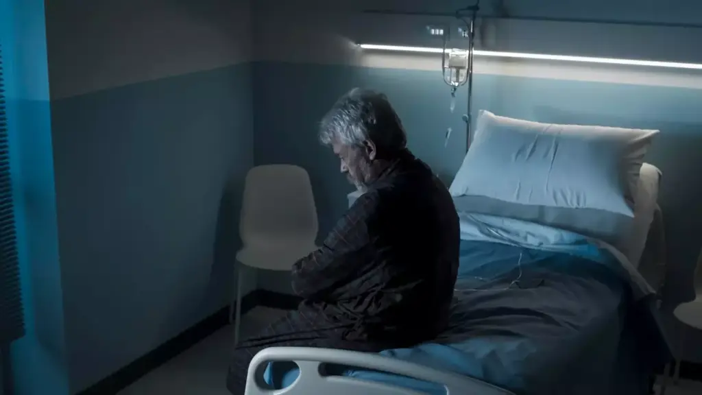 A middle-aged person, visibly weary and gaunt, sits alone in a dimly lit hospital room. Their face bears the weathered signs of a prolonged battle, with sunken eyes and a pained expression. The background is muted, with sterile medical equipment and a window overlooking a bleak, overcast cityscape, symbolizing the sense of isolation and loss of normalcy. The lighting is somber, casting long shadows and highlighting the subject's vulnerability. The overall atmosphere conveys the profound personal toll of cancer treatment, a somber and introspective depiction of the lasting effects on a patient's physical and emotional well-being.
