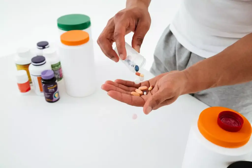 A neatly organized display of various over-the-counter joint pain medications on a clean, well-lit countertop. In the foreground, a selection of common pain relief pills, capsules, and ointments, each clearly labeled with their active ingredients. The middle ground features a range of topical creams, gels, and sprays, showcasing their diverse formulations. In the background, a blurred but recognizable pharmacy or drugstore setting, conveying a sense of professional medical environment. The lighting is soft and even, highlighting the products' textures and colors in a natural, appealing manner. The overall mood is one of informative clarity, guiding the viewer through the types of joint pain relief options available.
