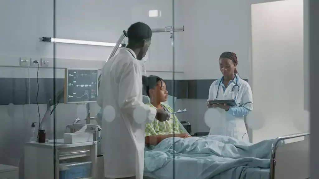 A serene medical setting, with a patient resting comfortably in a hospital bed, surrounded by empathetic healthcare professionals. The room is bathed in warm, natural lighting, casting a gentle glow on the scene. In the foreground, a nurse carefully checks the patient's vitals, while in the middle ground, a doctor discusses the recovery plan. The background features soothing, abstract artwork on the walls, conveying a sense of tranquility and healing. The overall atmosphere is one of care, compassion, and the gradual progress towards wellness.