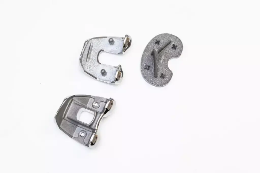 A sleek, high-tech display showcasing a variety of custom knee replacement implant models, each with distinct design features and branding. The foreground features a clean, minimalist arrangement of the implants, with carefully lit and angled shots to highlight their material compositions, joint mechanisms, and sculpted contours. The middle ground includes technical diagrams and schematics providing insights into the engineering and biomechanics of the devices. The background is a softly blurred, laboratory-like environment, conveying a sense of clinical precision and innovation. The overall mood is one of precision, sophistication, and the advancement of orthopedic medical technology.