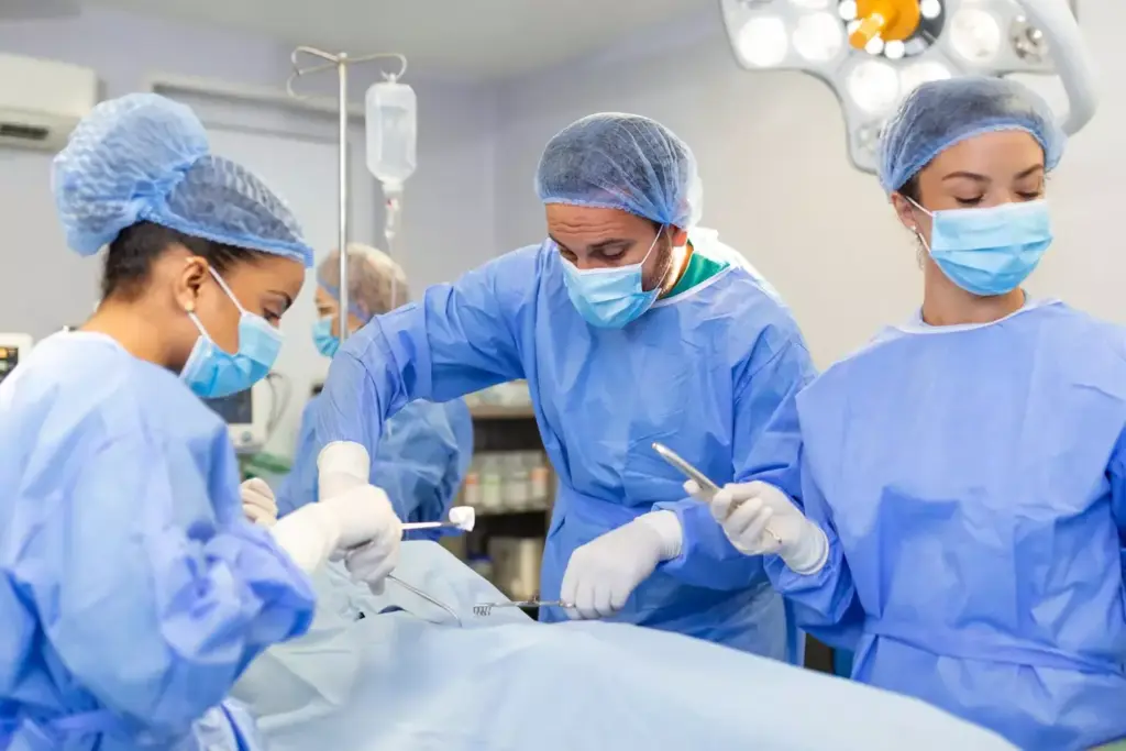 A well-lit, modern operating room filled with a team of skilled medical professionals. In the foreground, a surgeon in a crisp white coat and blue scrubs delicately performs a surgical procedure, their hands steady and focused. Flanking the surgeon are nurses and assistants in sterile attire, meticulously monitoring equipment and providing support. The middle ground features the stainless steel medical instruments, trays, and technology essential for the operation, all bathed in a bright, clinical lighting. In the background, a sense of calm and precision pervades the space, with the team working in seamless harmony to ensure the patient's well-being. A well-lit, modern operating room filled with a team of skilled medical professionals. In the foreground, a surgeon in a crisp white coat and blue scrubs delicately performs a surgical procedure, their hands steady and focused. Flanking the surgeon are nurses and assistants in sterile attire, meticulously monitoring equipment and providing support. The middle ground features the stainless steel medical instruments, trays, and technology essential for the operation, all bathed in a bright, clinical lighting. In the background, a sense of calm and precision pervades the space, with the team working in seamless harmony to ensure the patient's well-being.