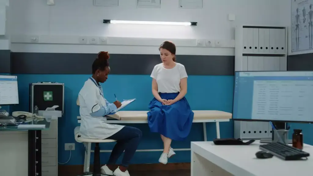 A well-lit, realistic scene depicting a serene medical office setting. In the foreground, a female patient sits comfortably on an exam table, her expression calm and attentive as a female doctor in a white coat examines her. The middle ground showcases various modern medical equipment and supplies, conveying a sense of advanced, high-quality care. The background features tasteful, soothing decor elements like potted plants and abstract artwork, creating a warm, welcoming atmosphere. The lighting is soft and diffused, highlighting the professionalism and care of the medical staff. The overall scene conveys the benefits of female outpatient procedures - a safe, comfortable, and empowering healthcare experience.