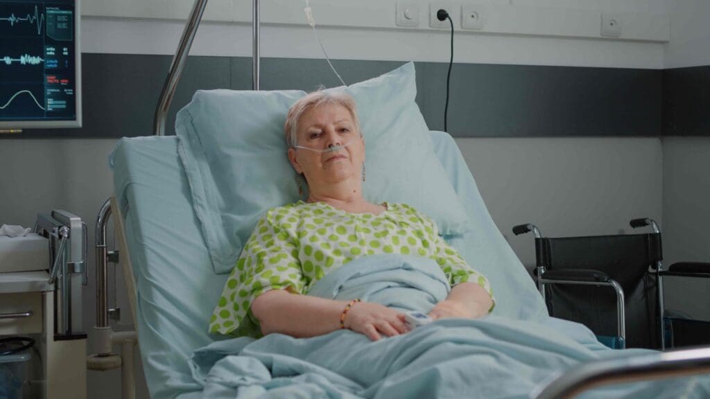 A woman reclines on a hospital bed, her face a mix of determination and vulnerability as she undergoes chemotherapy for breast cancer treatment A woman reclines on a hospital bed, her face a mix of determination and vulnerability as she undergoes chemotherapy for breast cancer treatment