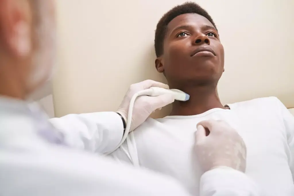 African man on ultrasound diagnosis of lymph nodes on neck