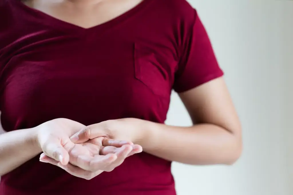 close-up of a person's hand and arm, showing the visible effects of breast cancer chemotherapy treatment