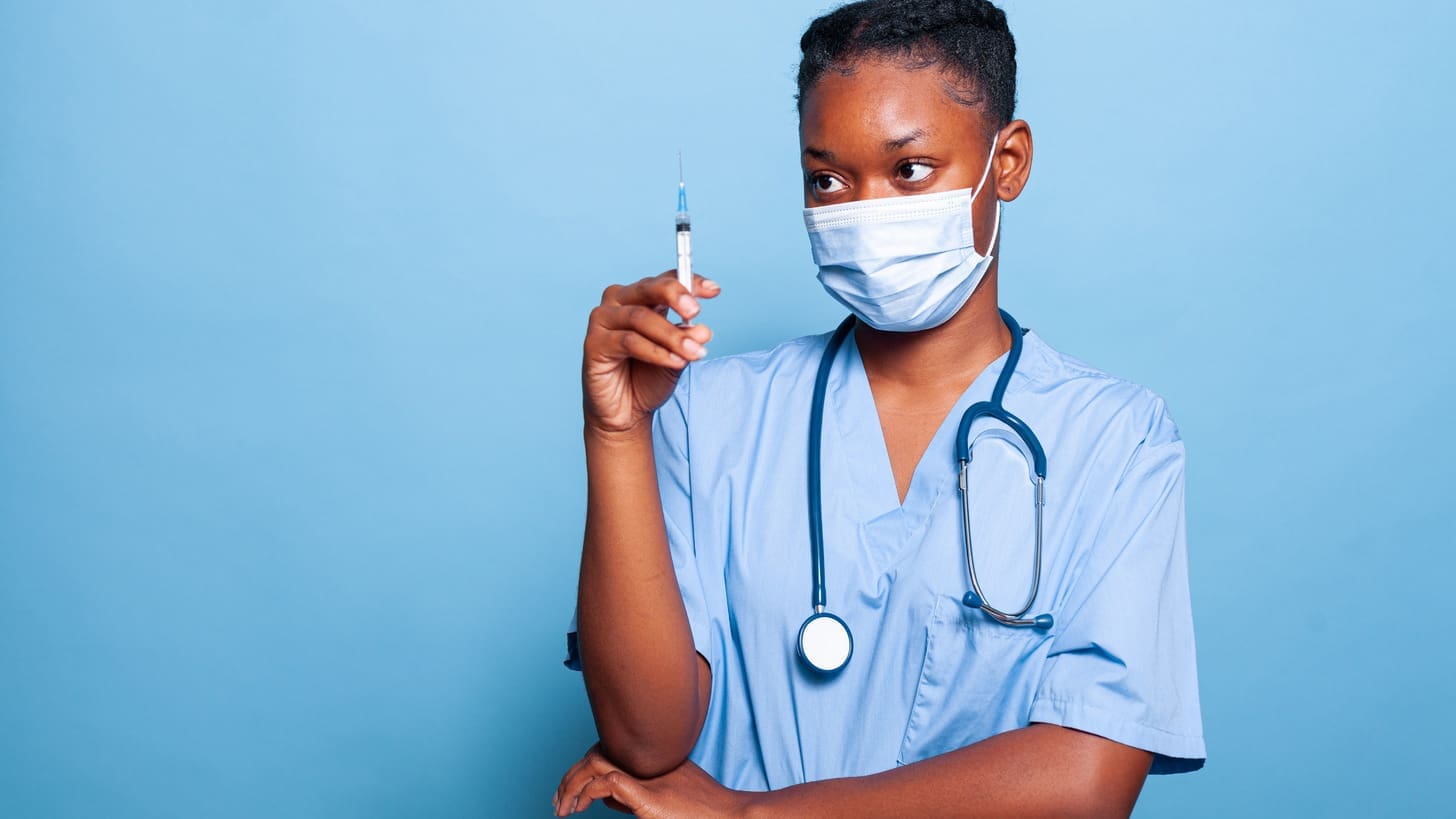 doctor injecting patient