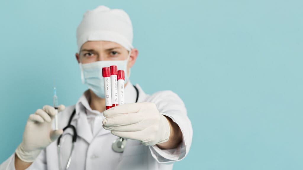 front view doctor holding vacutainers syringe with copy space LIV Hospital