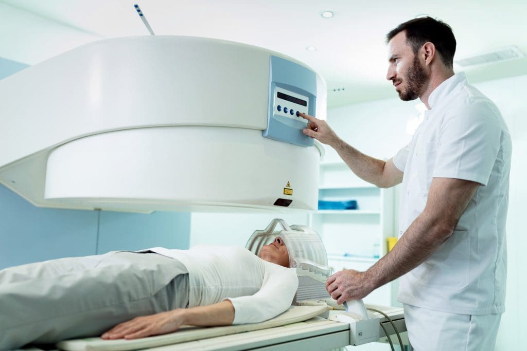 medical technician starting head mri scan procedure female patient hospital 3 LIV Hospital