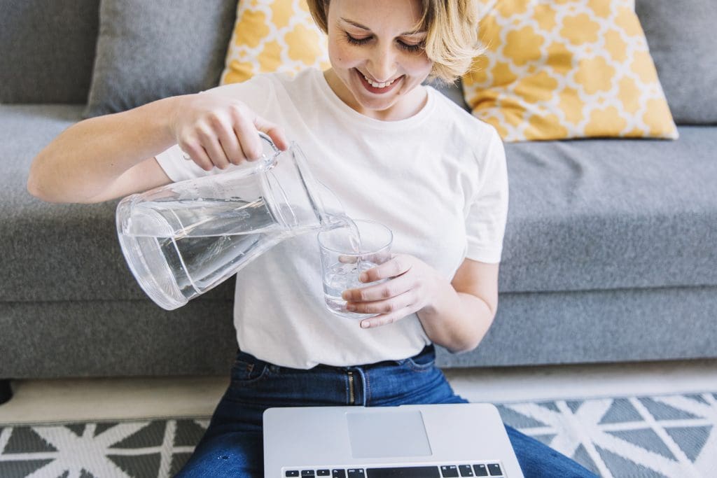 smiling woman with laptop pouring water LIV Hospital