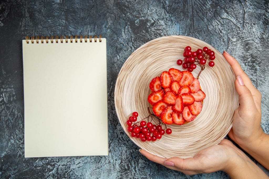 top view yummy strawberry cake with red berries dark background LIV Hospital