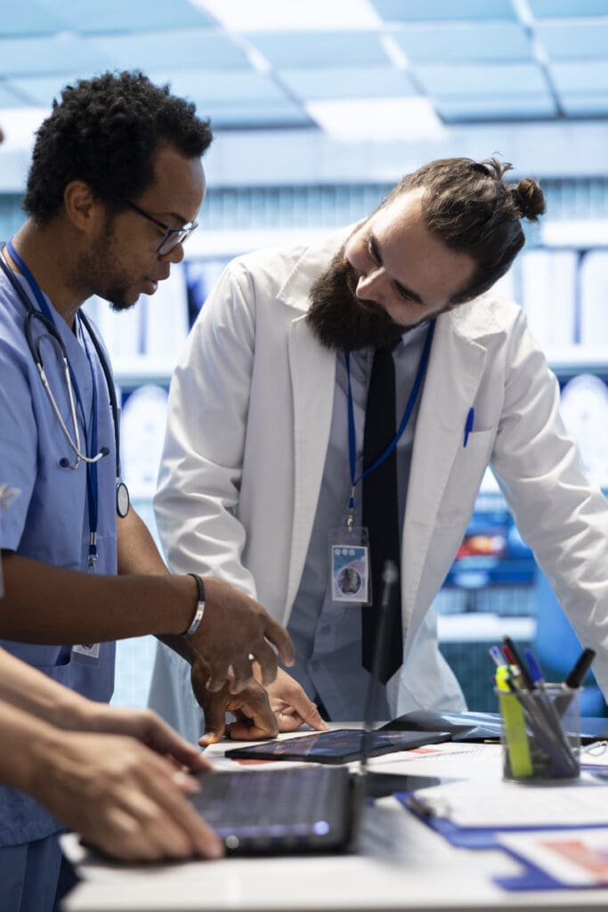 Healthcare professionals examine human anatomy scans to develop treatment plans