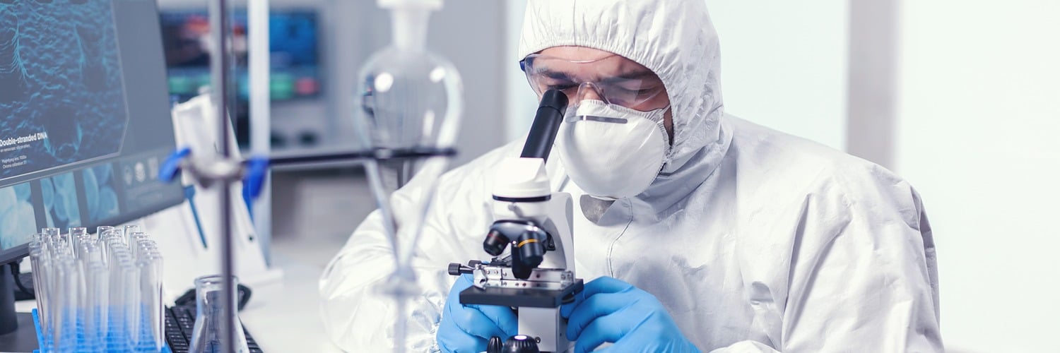 analyzing virus microbiology lab using microscope wearing ppe suit glasses x banner 1500 500 LIV Hospital